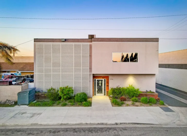 Commercial office building photographed from above at sunset